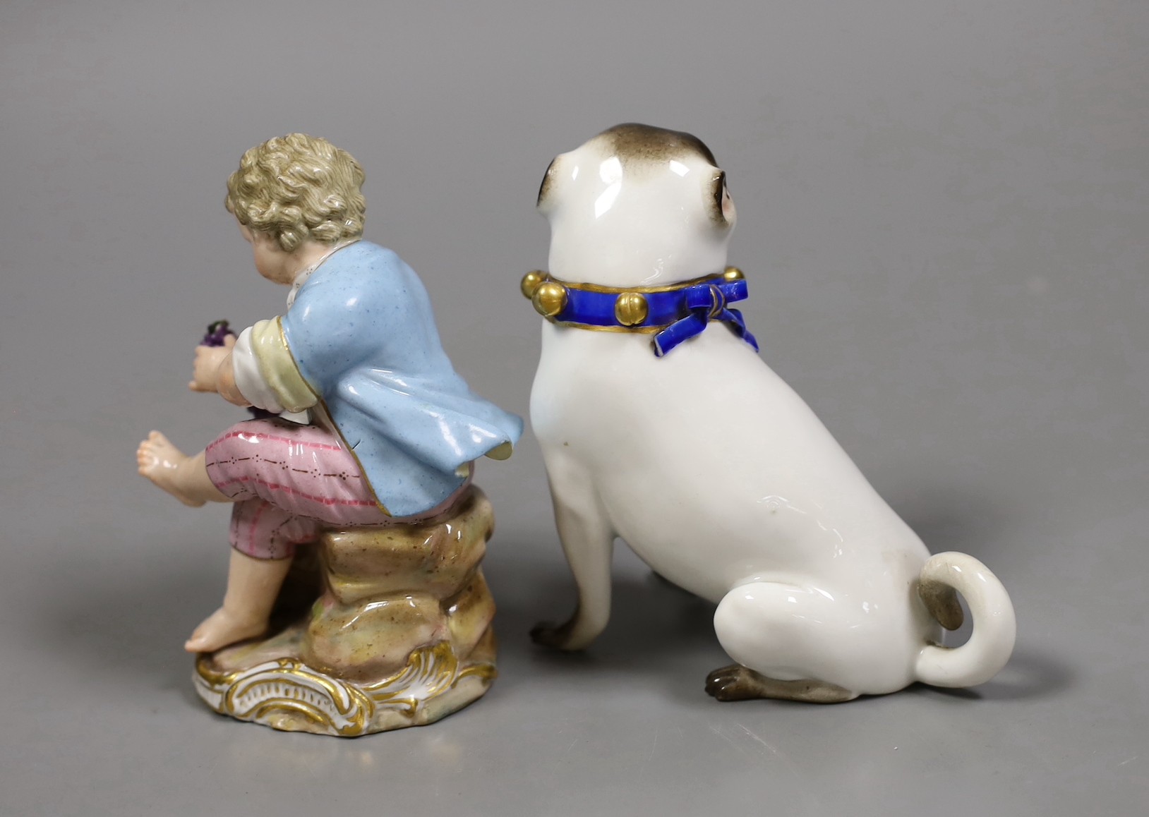 A late 19th century Meissen figure of a pug and a similar seated figure of a boy, tallest 10.5cm